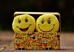 two smiling happy emojis