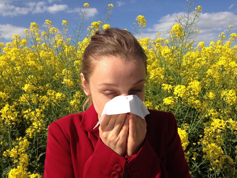 A person sneezing because of allergy