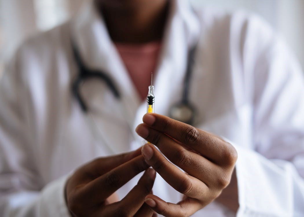 A doctor checking holding a vaccine