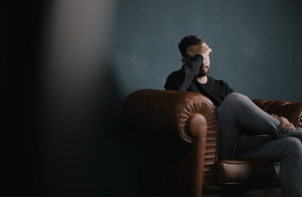 a depressed man sitting