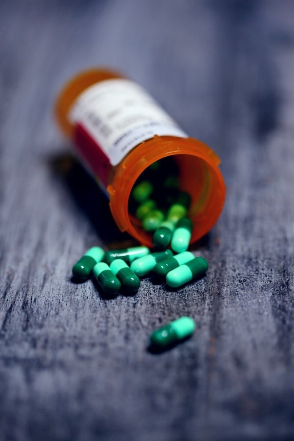 a bottle of green pills