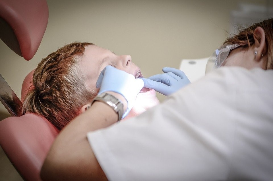 A dentist offering dental treatment to a child