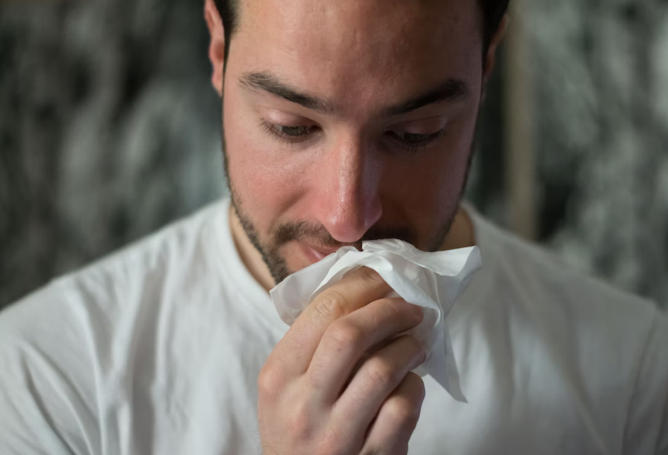 A person using a napkin to wipe their mouth