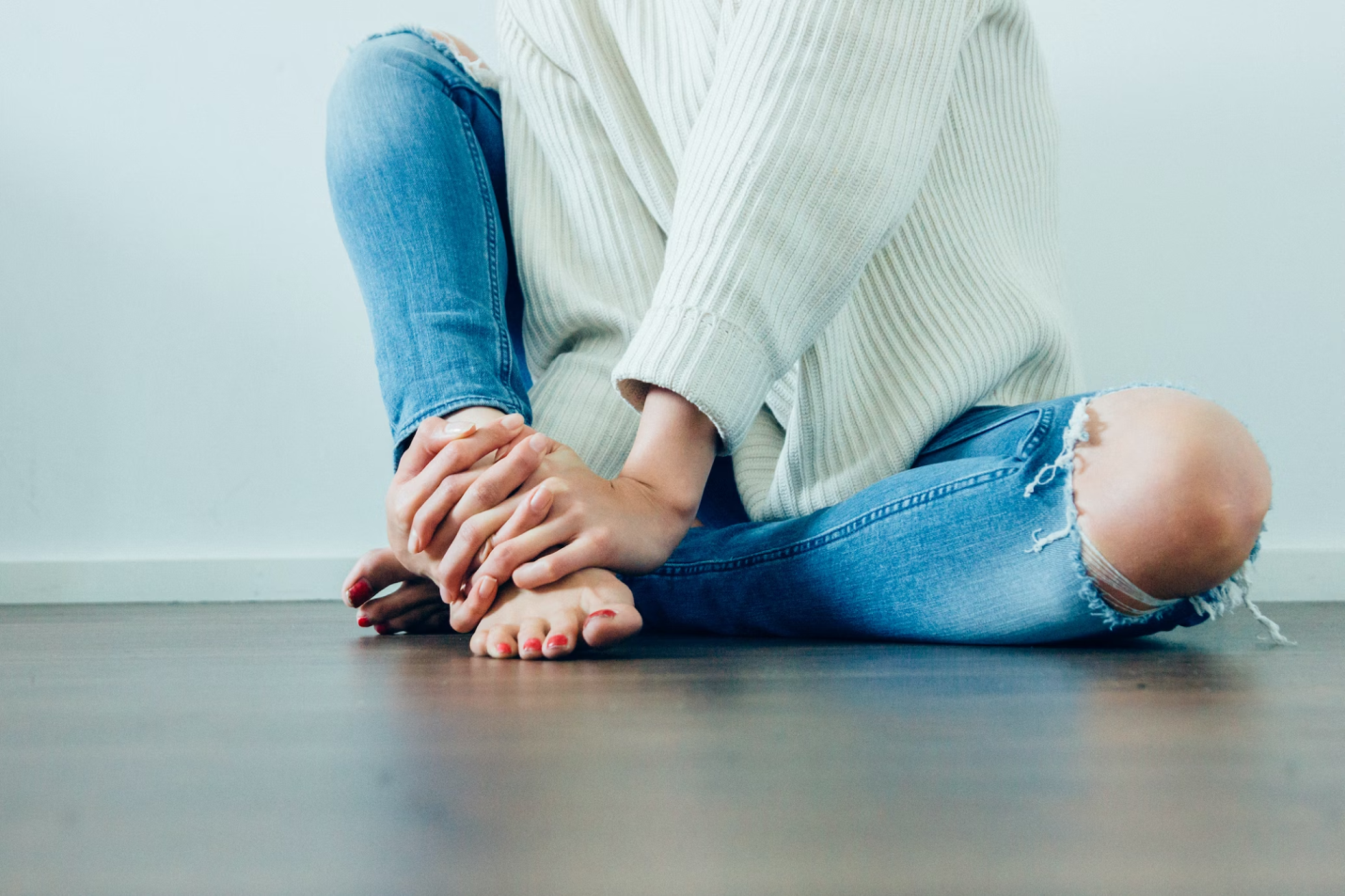 A photo showing a person holding their foot