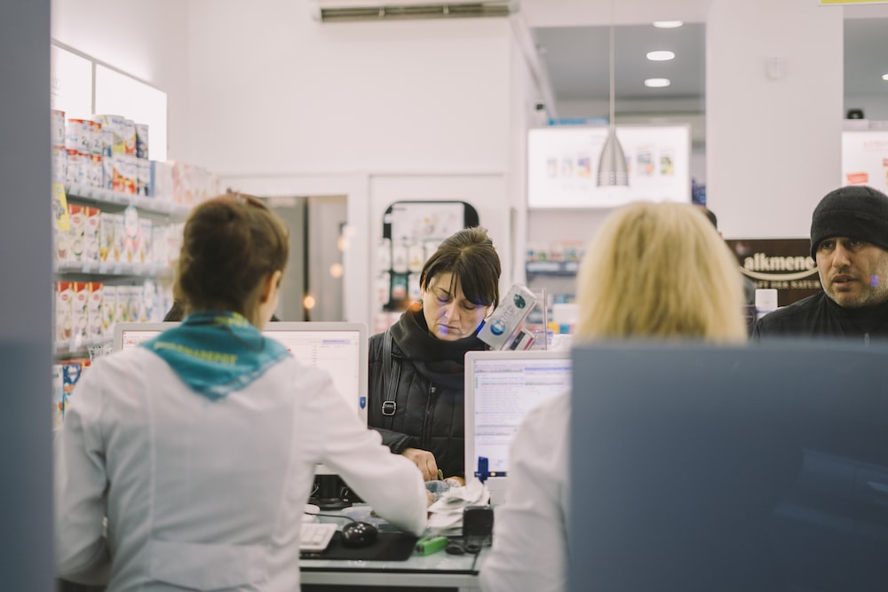 Several patient assistance agents at a medical store