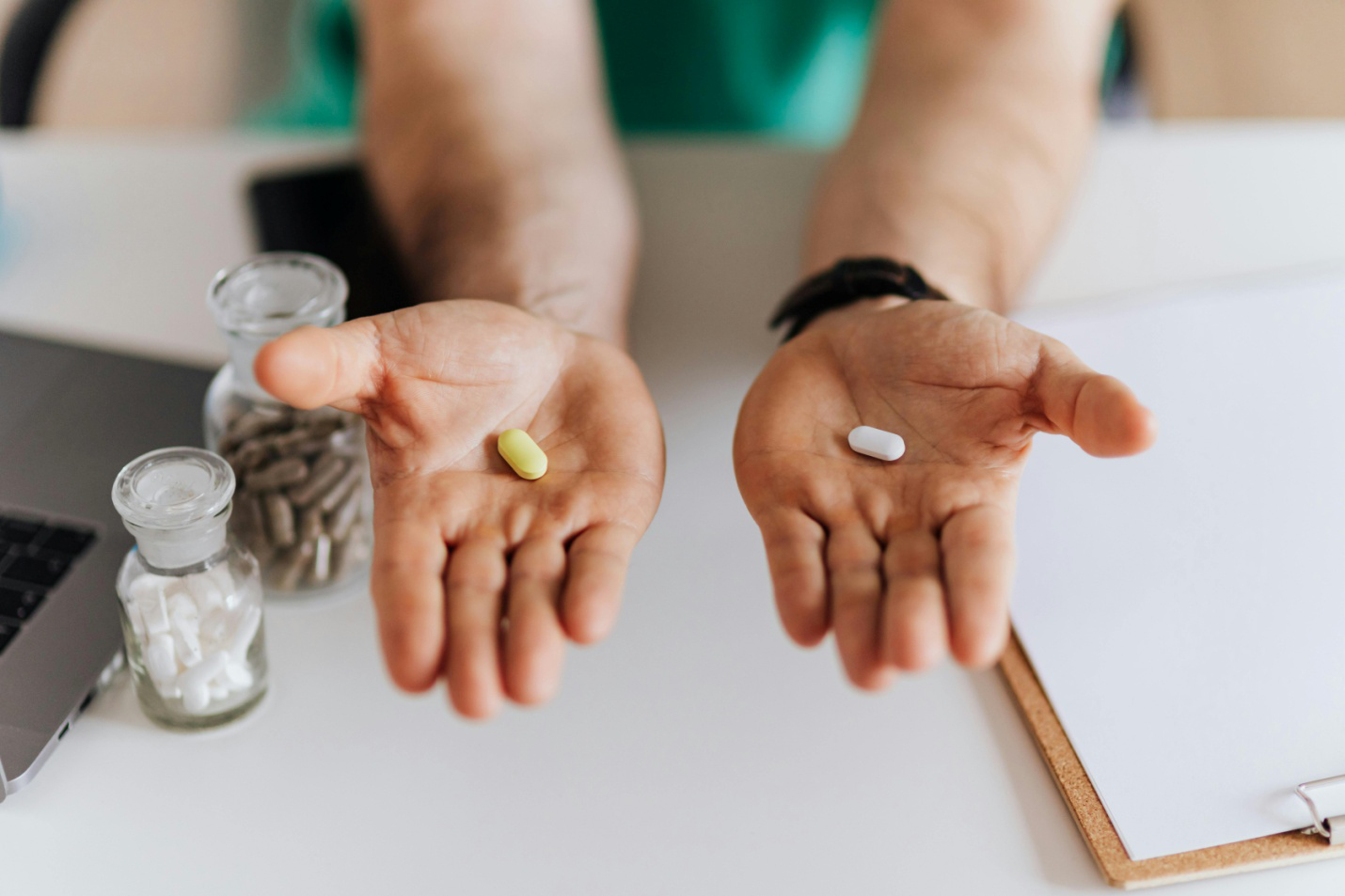 a person extending out two hands holding pills