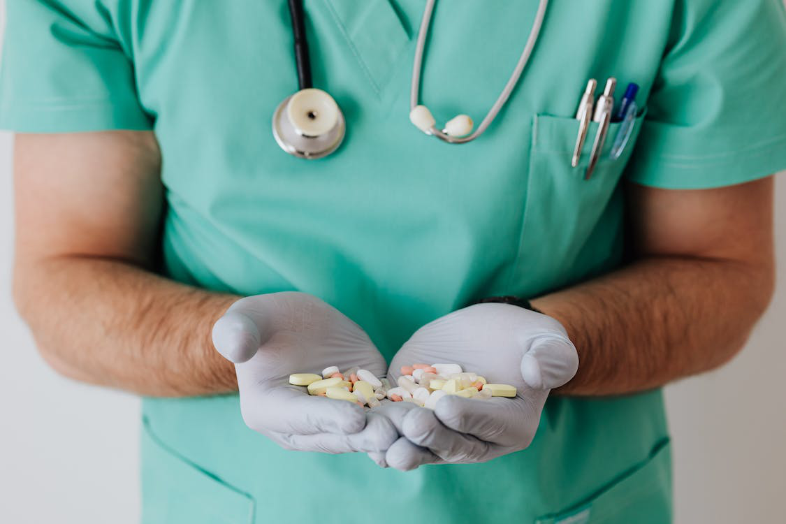 A doctor with pills in hand
